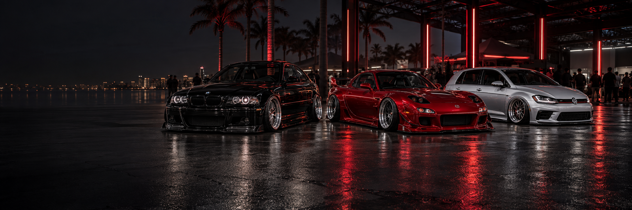 Lowered modified cars at an evening car show