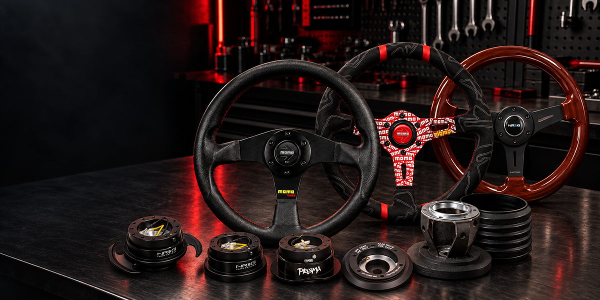 Illustrative steering wheels, hub adapters and quick releases on a workshop bench